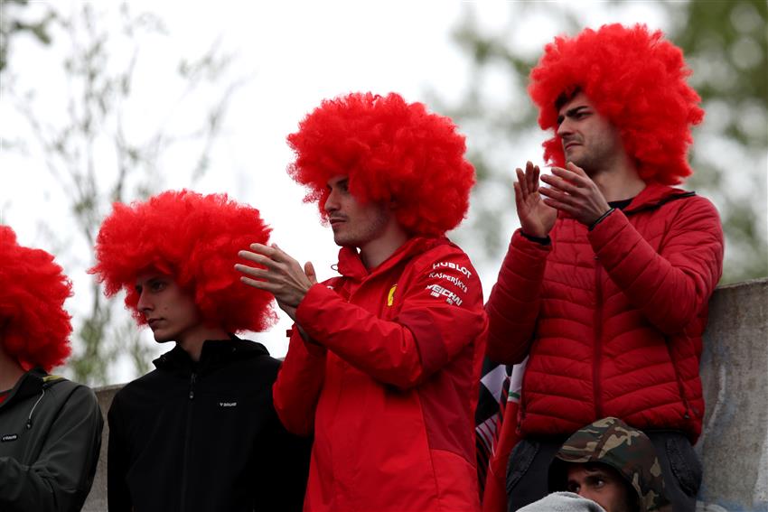 Fanatic race fans in red wigs